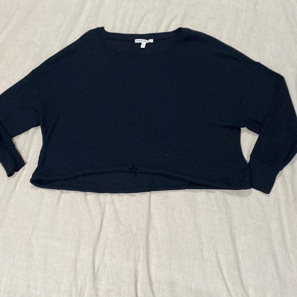 Black cropped top. Drawstring at bottom